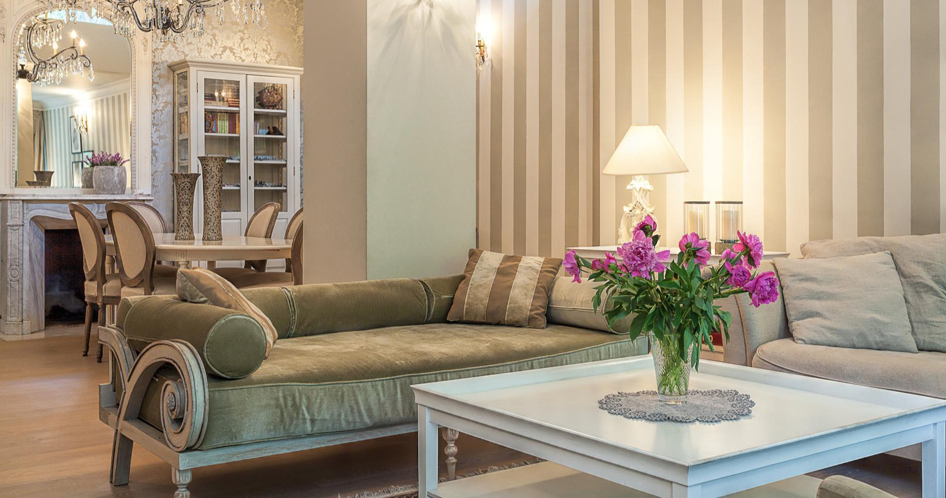 A fancy wallpapered livingroom.