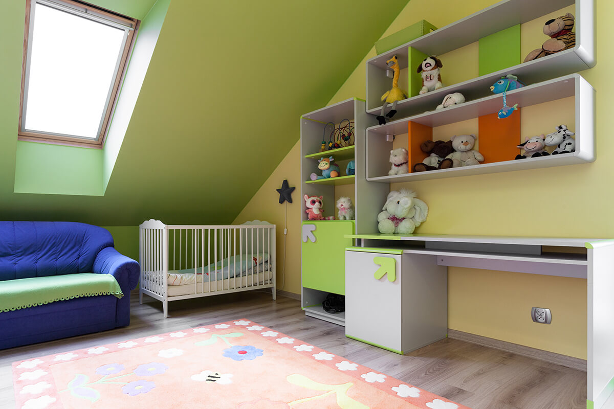 A child's room with walls painted green and yellow.