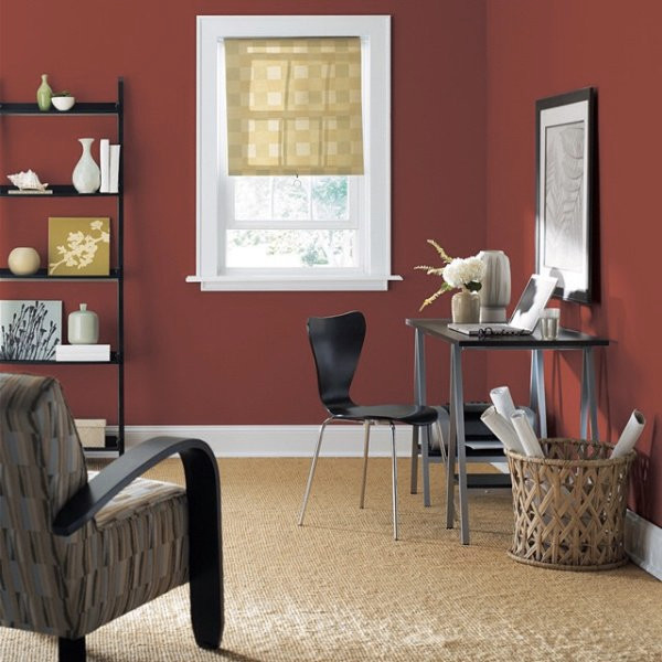 A brick red painted office with white trim.