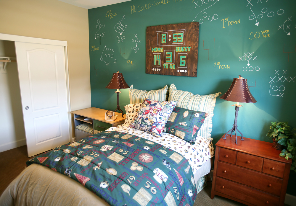 A football themed bedroom with a chalkboard wall